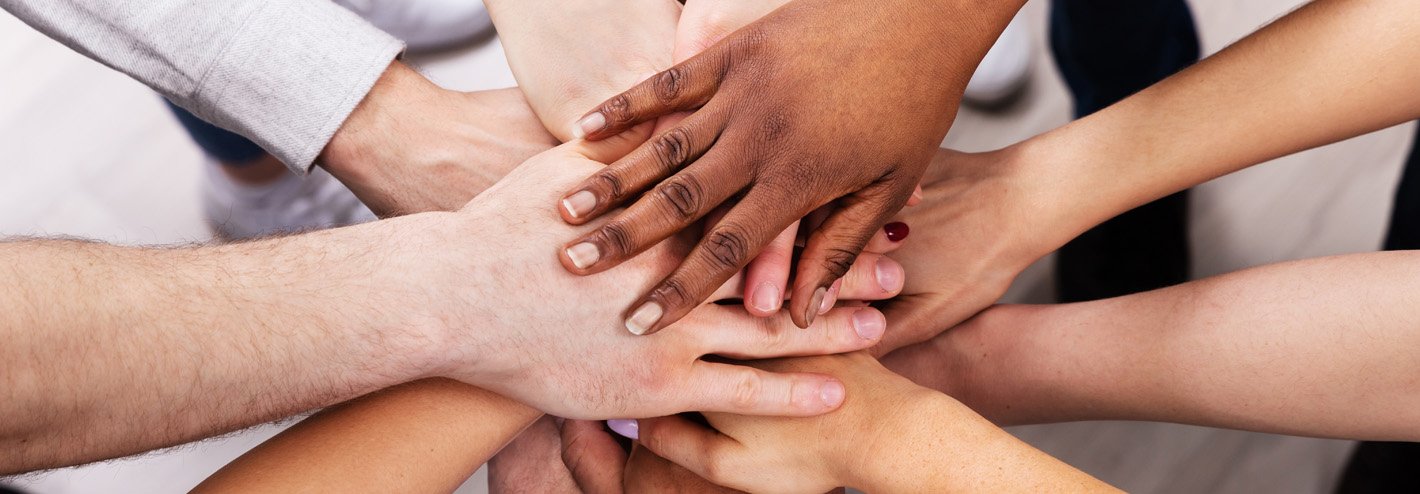 Hands stacked in center of group